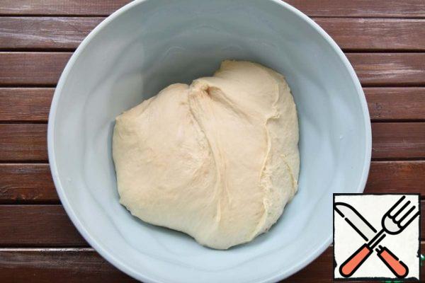 Knead a soft, slightly sticky dough. Cover the bowl with the dough with a kitchen towel and leave in a warm place to increase in volume.