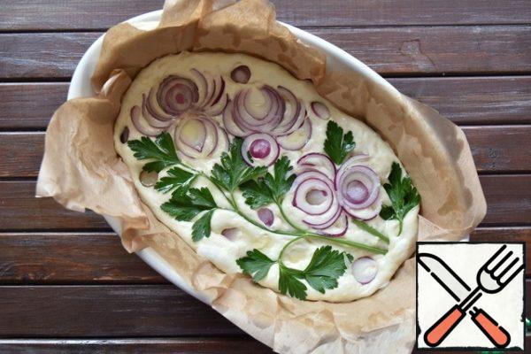 From this volume of dough, you can form one large or two medium Focaccia. Put the dough on parchment, greased with vegetable oil, giving a round or oval shape. Go over the entire surface of the Focaccia with your fingertips, lightly pressing and forming small depressions.
Put any pattern on the surface of the Focaccia using seasonal vegetables of different colors, herbs, mushrooms, olives, olives, capers. You can sprinkle Focaccia with coarse salt or a mixture of dried herbs.
As long as you show imagination and "draw", the bread will rise noticeably. Before baking, drizzle the Focaccia with olive oil and lightly press the "pattern" into the dough.
Bake Focaccia in the oven, preheated to 220 degrees for 20-25 minutes.