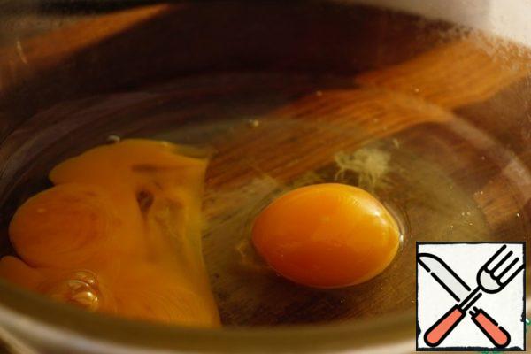 Break 2 eggs.