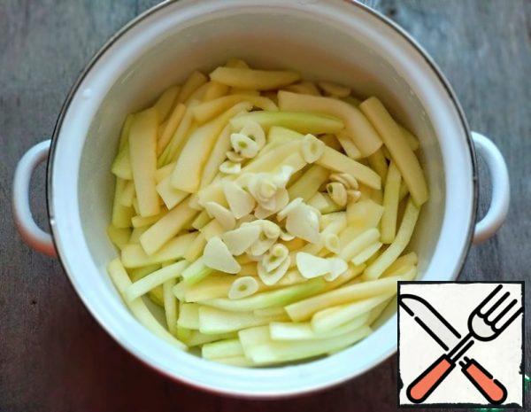 Add the chopped garlic to the zucchini.