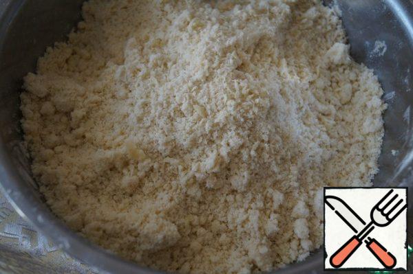 Sift the flour into a deep bowl, add the cold butter cut into pieces, and RUB everything thoroughly into crumbs.