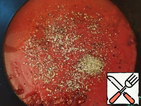 Add the tomato sauce, stock, salt, pepper, oregano and mix.
