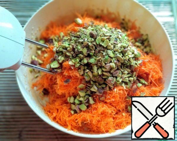 Add carrots and chopped pistachios to the dough.