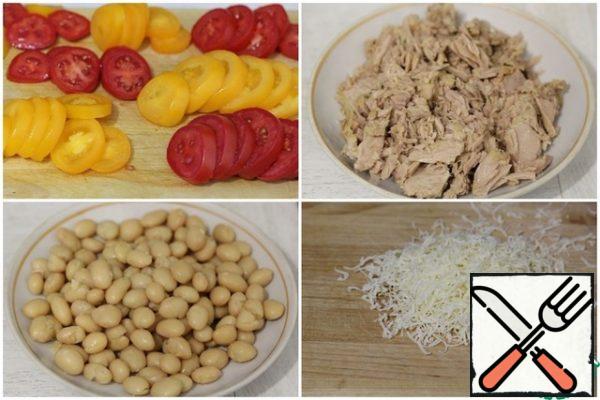 While the base is baking, prepare the filling:
- mix the tuna slices with the zest of half a lemon;
- wash the beans (white or red, no difference);
– grate the Parmesan on a fine grater;
- cut tomatoes into slices.