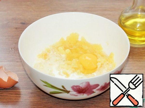 Add warm milk, vegetable oil, and egg to the potatoes..