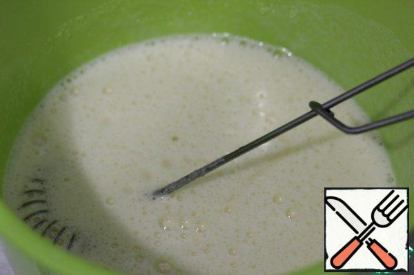 Pour in the lemon juice, vegetable oil, add the lemon zest, and beat again.