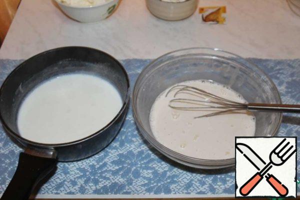 In the resulting mixture, add a little warmed milk and mix well.