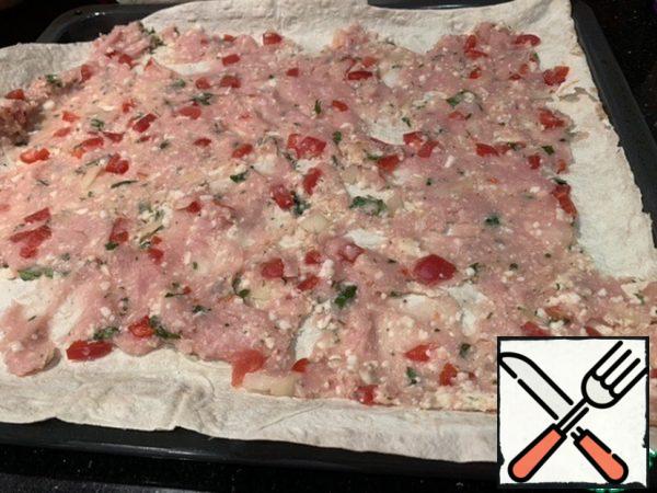 Each sheet of pita bread is literally smeared with minced meat.