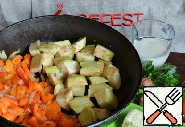 Peel the eggplant, slice it, and add it to the pan.