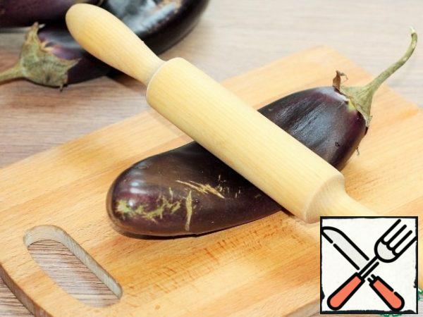 Roll out the eggplant with a rolling pin until soft.