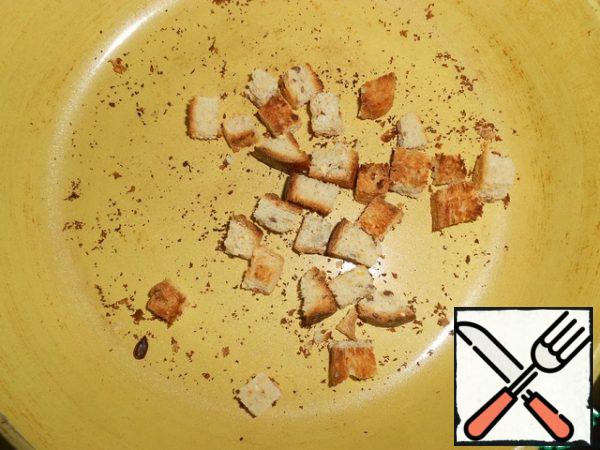 Brown the white bread cubes in a dry pan.