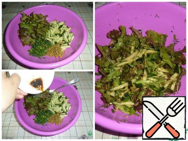Put the sliced cucumbers, herbs, olives and lettuce leaves in a working bowl. Add the prepared dressing. Mix gently.