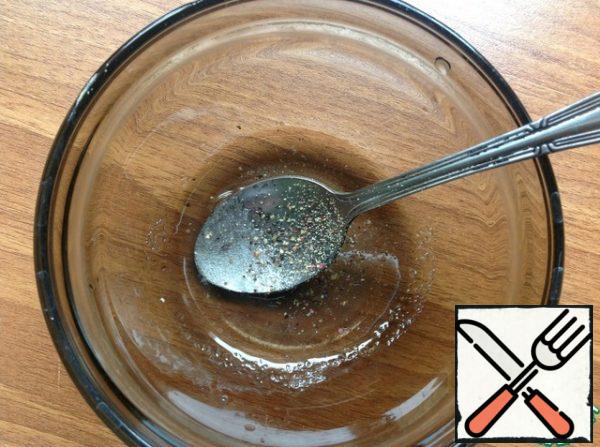 First, we'll make a marinade dressing. In a bowl, mix the oil, vinegar, pepper and sugar.