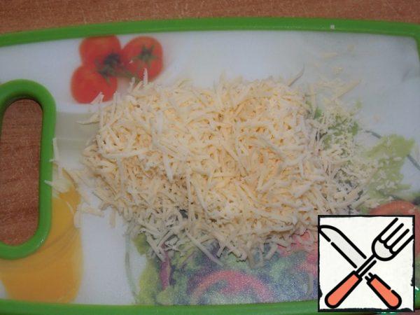 Grate cheese on a grater.