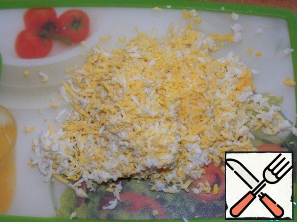 Grate the eggs.