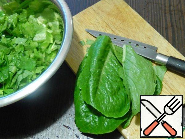 Wash, dry and slice the lettuce leaves. For dressing, mix olive oil with balsamic vinegar and almond essence.