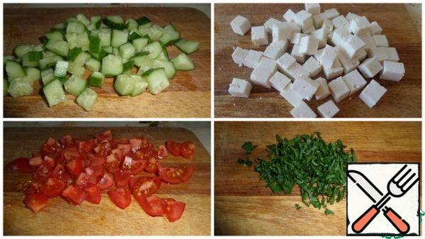 Cut the vegetables into cubes. Chop the greens.