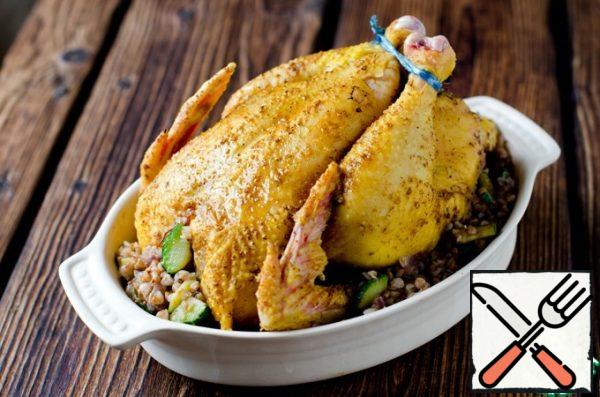 Stuff the chicken with stuffing and tie its legs with twine. If there is a filling left, then put it in a heat-resistant form, and put the chicken on it, so the buckwheat will absorb all the fat and get even tastier.
