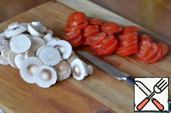 Cut tomatoes into slices.
Peel the mushrooms and cut them in half.