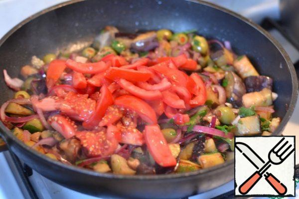 Add the tomatoes.
Add salt and pepper to taste. Simmer for 2 minutes.