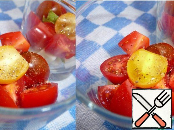 Cut tomatoes into halves. Put on the cheese. Season with salt and pepper and add olive oil.