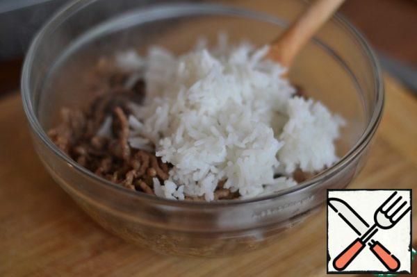 Add soy sauce . 
Stir. Remove from heat. In a separate bowl, mix the rice and fried meat.
Add egg. Stir.