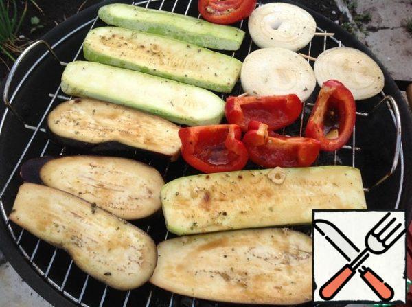 Then put the vegetables on a barbecue net and place on the grill, where the coals are ready. Fry the vegetables on one side for 10 minutes, then flip and fry the other side.
