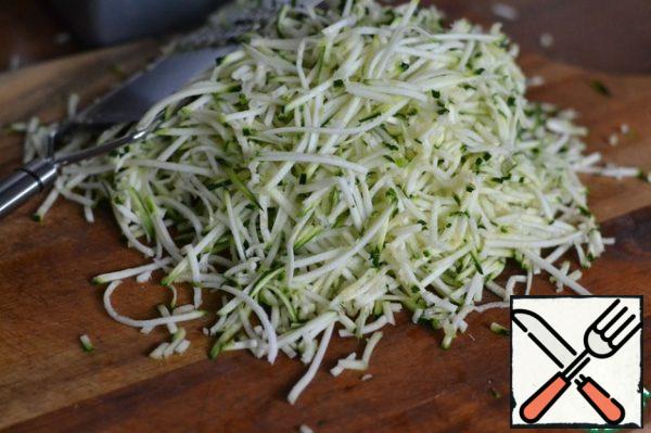 Grate the zucchini on a Korean carrot grater or cut it into very thin strips with a knife.