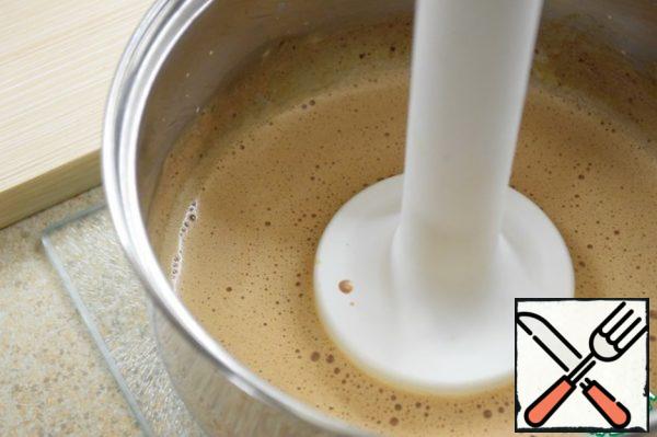Remove from heat. Add the chocolate and cinnamon. Using an immersion blender, whisk the mixture until a fluffy foam forms.