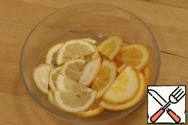 Cut the lemon and orange into semicircles.