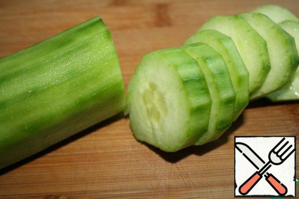 Peel the cucumber and cut it into pucks.