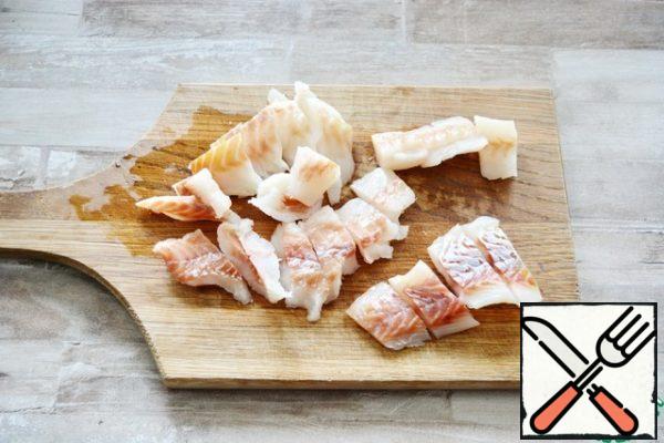 Cut the Pollock fillet into small pieces.
