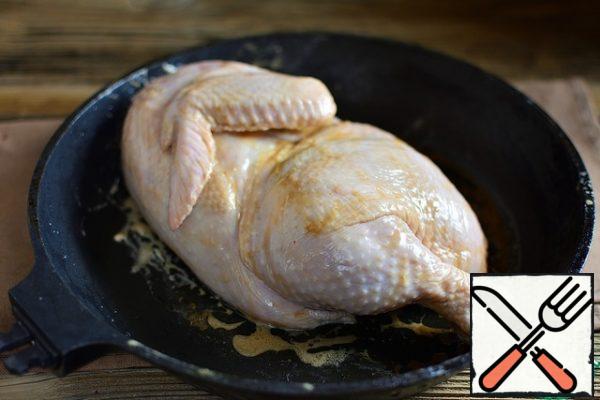 Put the chicken in a heat-resistant form, pour 1/3 of the sauce and RUB it into the chicken from all sides.