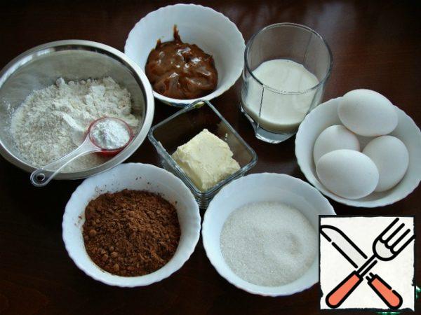 Prepare all the necessary ingredients for a chocolate-caramel sponge cake.