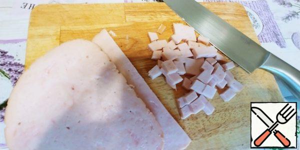 Cut the prosciutto into a cube.