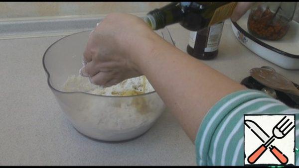Add the vegetable oil and mix it into the dough. We should make it soft and elastic.