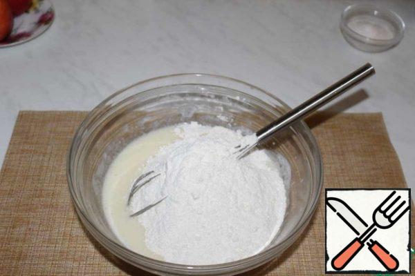 In the resulting mixture, add the sifted flour with baking powder.