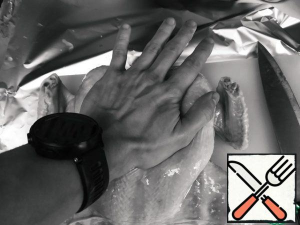 Let's turn the chicken over and press hard on the chest, as if using artificial respiration.