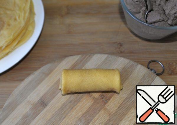 Roll the pancake into a tube.