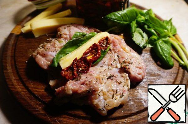 For each piece of chicken, put Basil leaves, mozzarella bars on them, and dried tomatoes next to them.