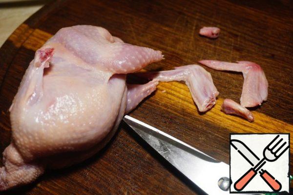 Cut off 2 phalanges of wings and the tips of the legs.