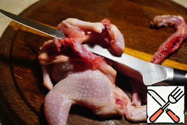 With a thin knife, we begin to separate the meat from the bone. When we reach the legs and wings, we break them at the joints and leave these bones for now.