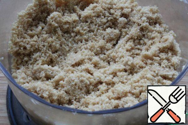 Cookies grind into crumbs.
Add the soft butter and stir.