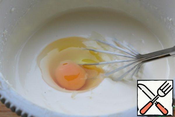 Then add one egg at a time, mixing thoroughly each time with a whisk.