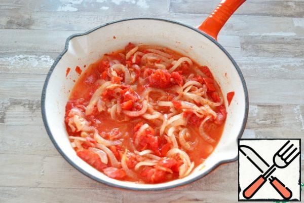 Add the tomatoes mashed with a fork in their own juice to the onion. Simmer the tomatoes and onions for about 5 minutes, add salt and sugar.

You can also use sliced fresh or frozen tomatoes. If desired, remove the skin from them, dropping them for 1 minute in boiling water.