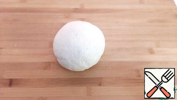 Knead the dough. Cover with a bag and leave for 1 hour.