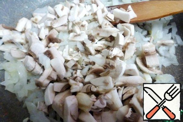 Add the chopped mushrooms to the onion and fry until the mushrooms are reduced in size and almost all the juice has evaporated. But don't fry the mushrooms and onions until they are brown!