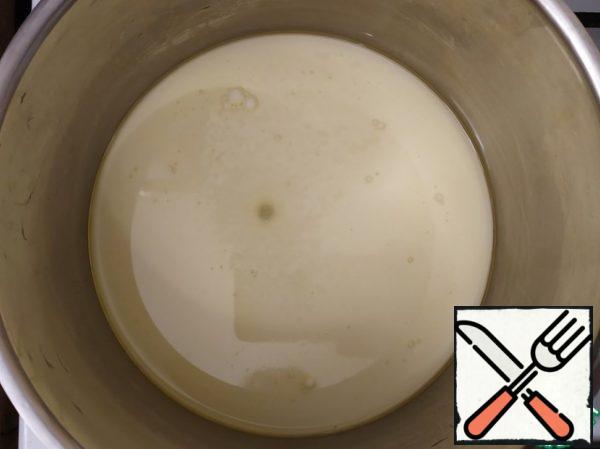 Pour the milk into a saucepan, add the butter and salt and bring to a boil.