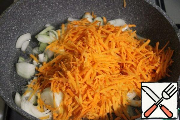 Grate the carrots and add them to the onion and simmer for 15 minutes.