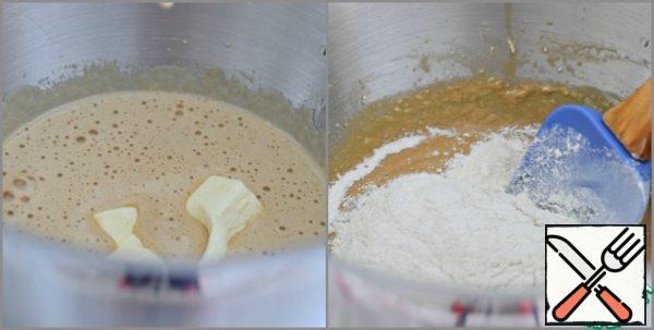 Add the softened butter to the egg-sugar mixture. Whip.
Sift both types of flour with baking soda, baking powder and salt. Add the flour mixture to the egg-sugar mixture in parts, stirring gently but thoroughly with a spatula.